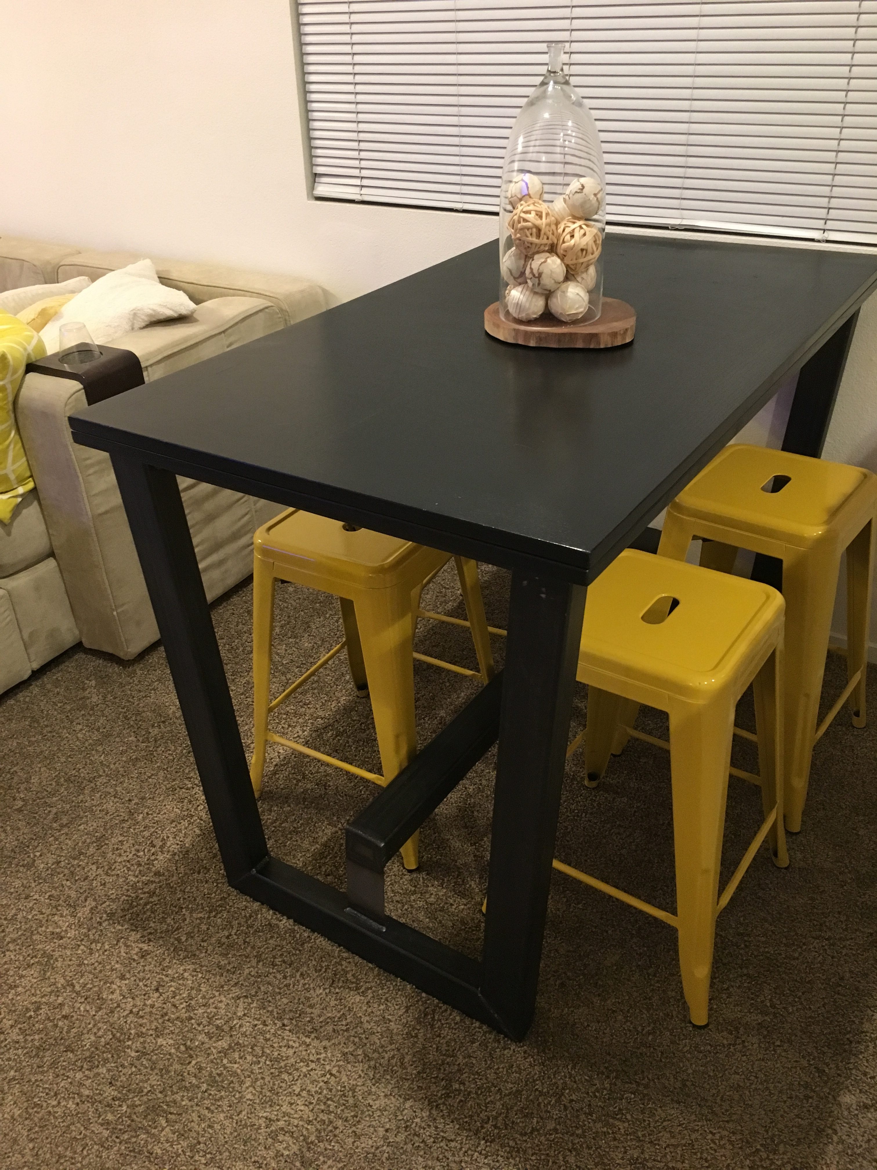 Folded table in its smaller form, on new bar height metal base with foot rest.